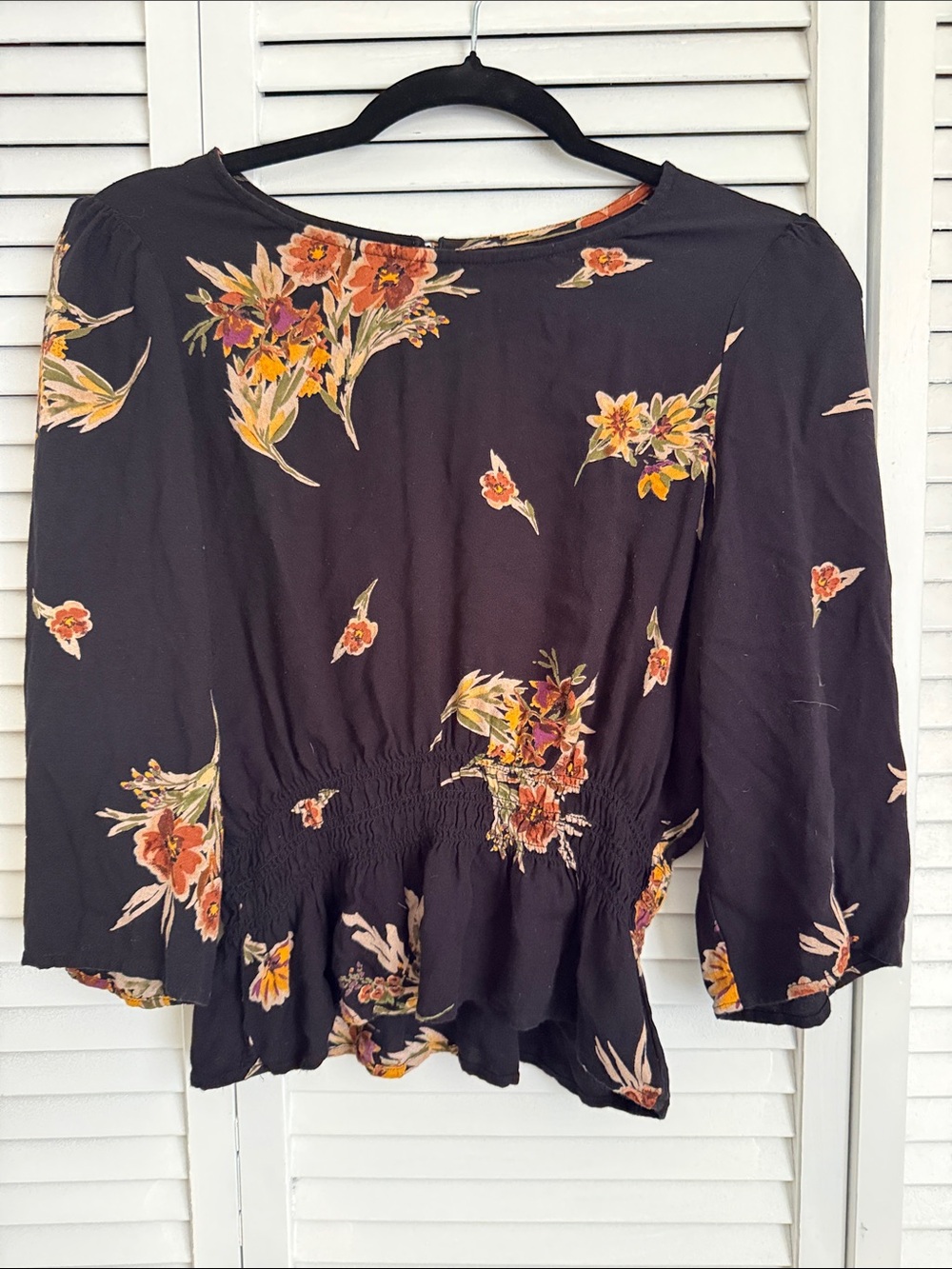 saltwater LUXE Black Floral Peplum Blouse with Orange & Yellow Accents